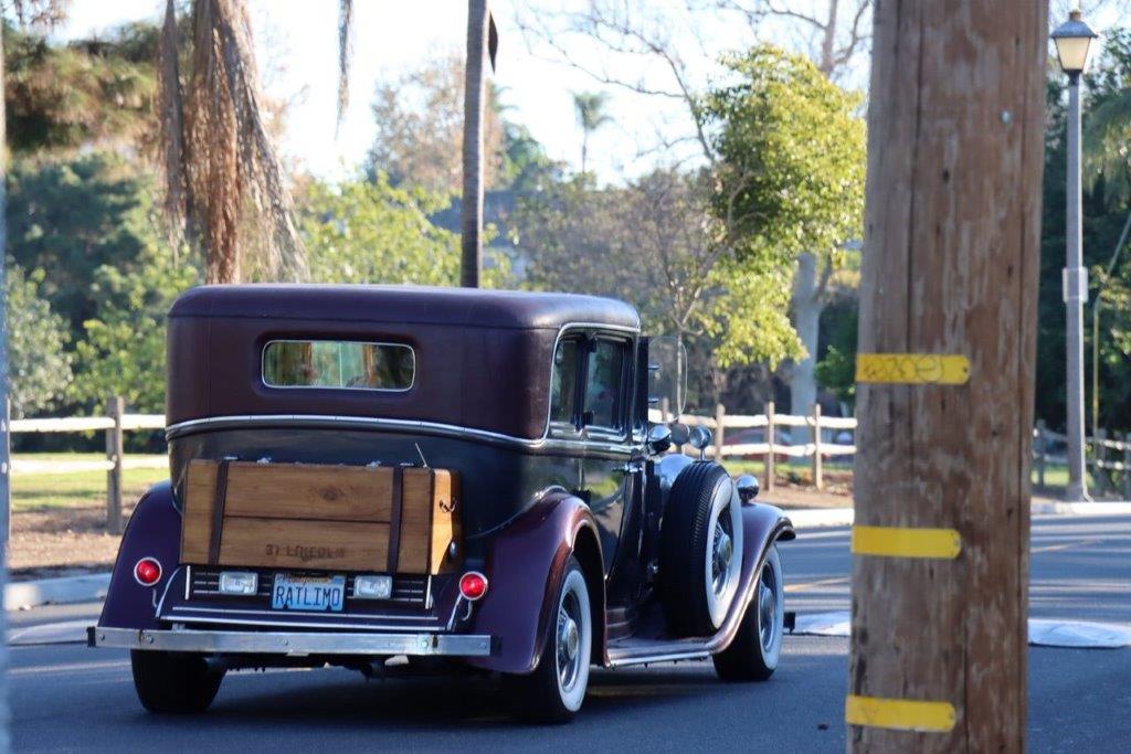 An old car on the road

Description automatically generated