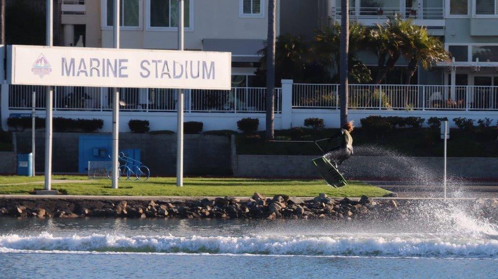 A person on a wakeboard jumping

Description automatically generated