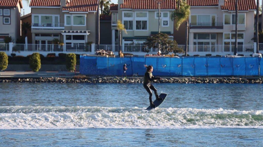 A person on a surfboard in the water

Description automatically generated