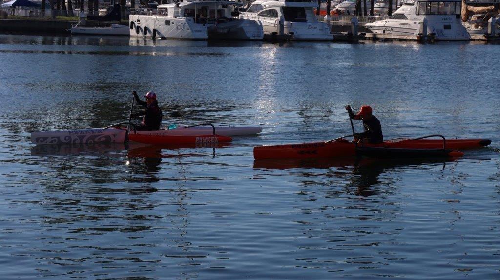 A couple of people in kayaks on a lake

Description automatically generated