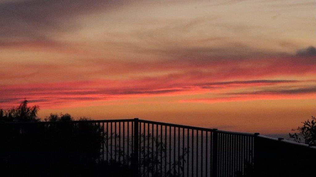 A sunset over a fence

Description automatically generated