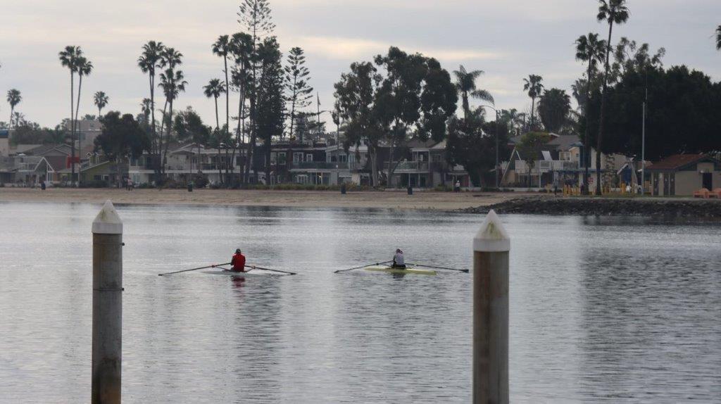 A group of people rowing in a body of water

Description automatically generated