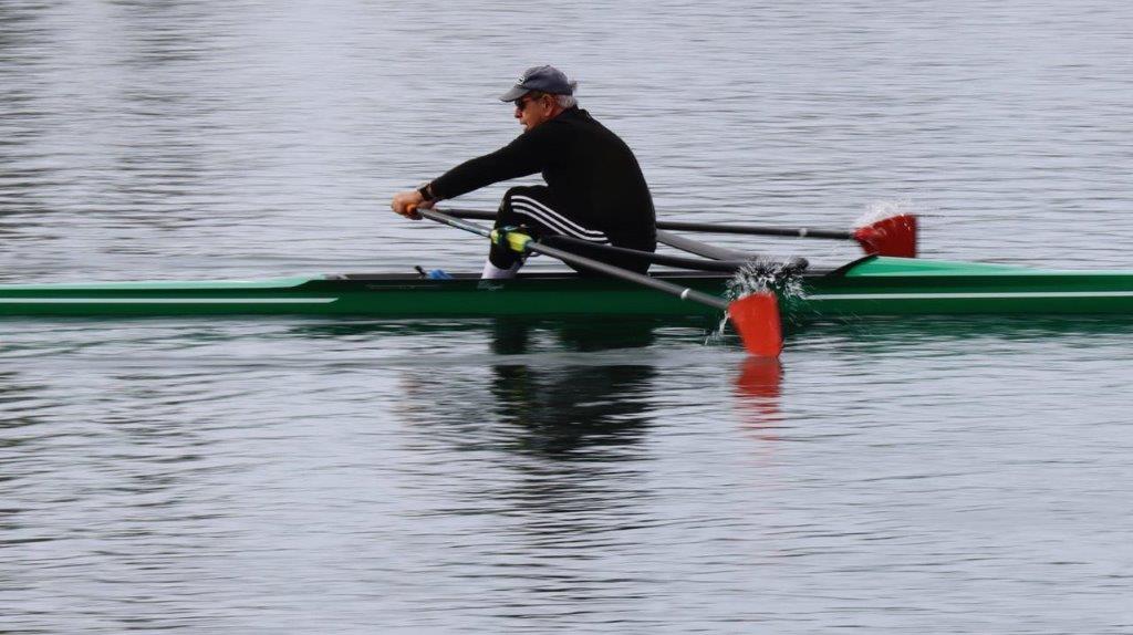 A person rowing a boat on the water

Description automatically generated