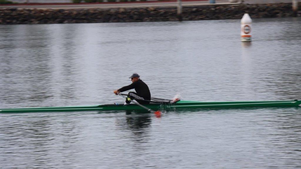 A person rowing a boat on the water

Description automatically generated