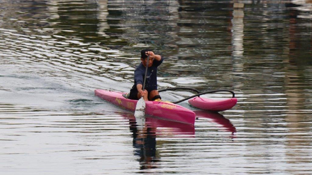 A person in a kayak on a lake

Description automatically generated