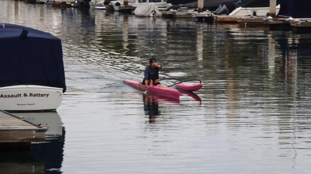 A person in a kayak on a lake

Description automatically generated