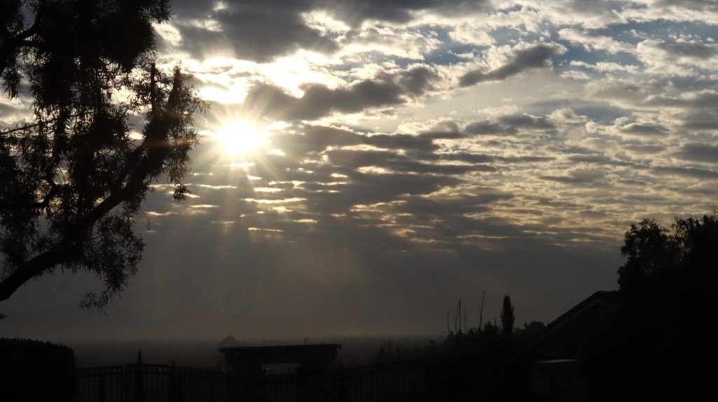 Sun shining through clouds in the sky

AI-generated content may be incorrect.