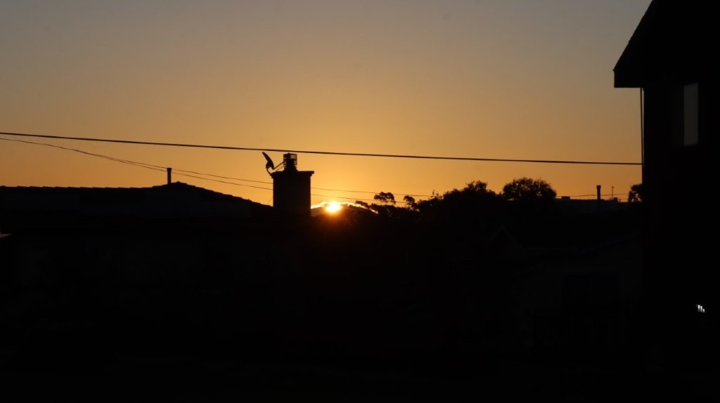 A silhouette of a building and trees during sunset

AI-generated content may be incorrect.
