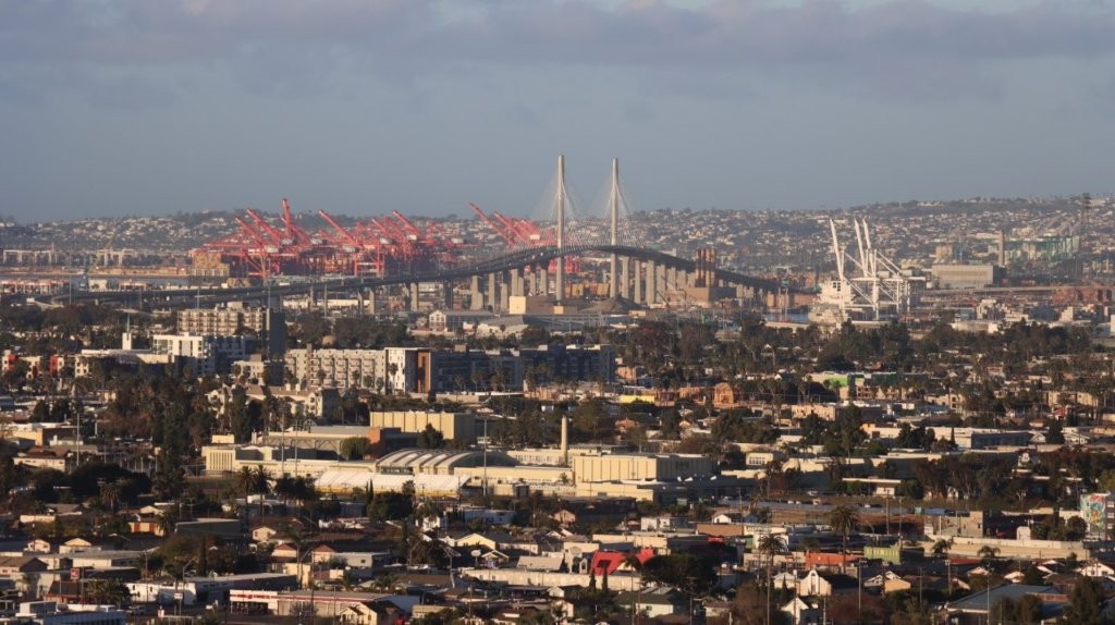 A city with a bridge in the background

AI-generated content may be incorrect.
