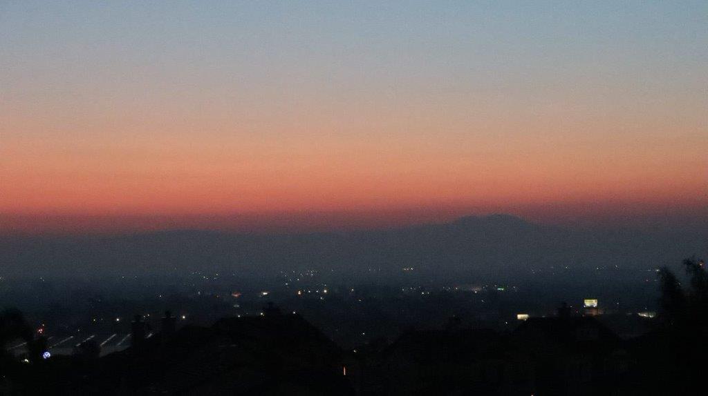 A sunset over a city

Description automatically generated