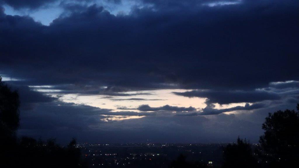 A dark sky with clouds

Description automatically generated