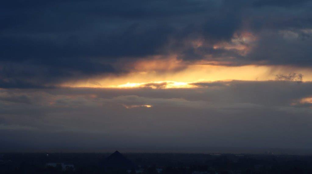A sun shining through clouds

Description automatically generated