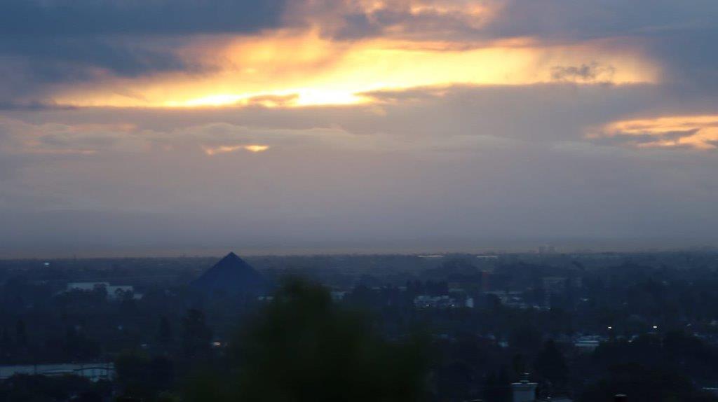 A sunset over a city

Description automatically generated