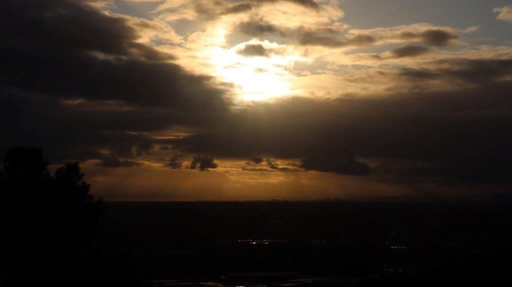 A sun shining through clouds

Description automatically generated