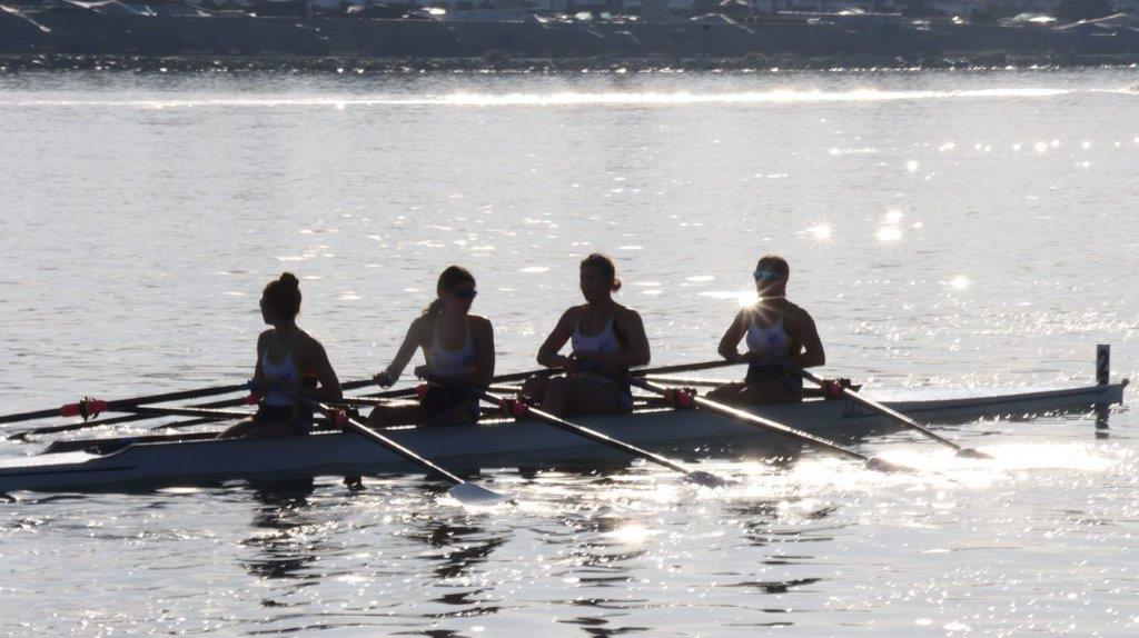 A group of people rowing a boat

Description automatically generated