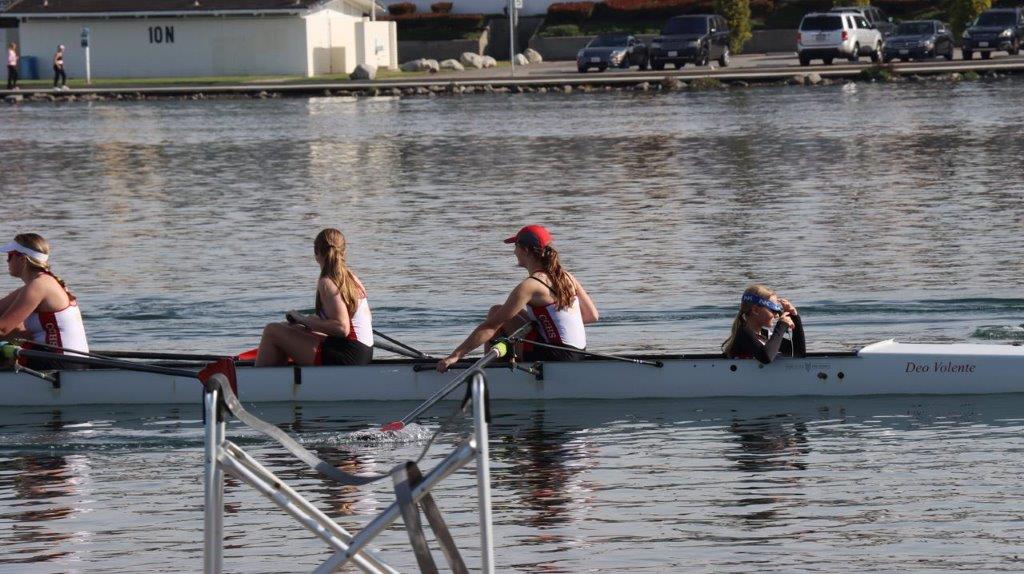A group of people rowing a boat

Description automatically generated