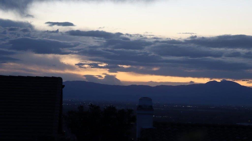 A sunset over a city

Description automatically generated