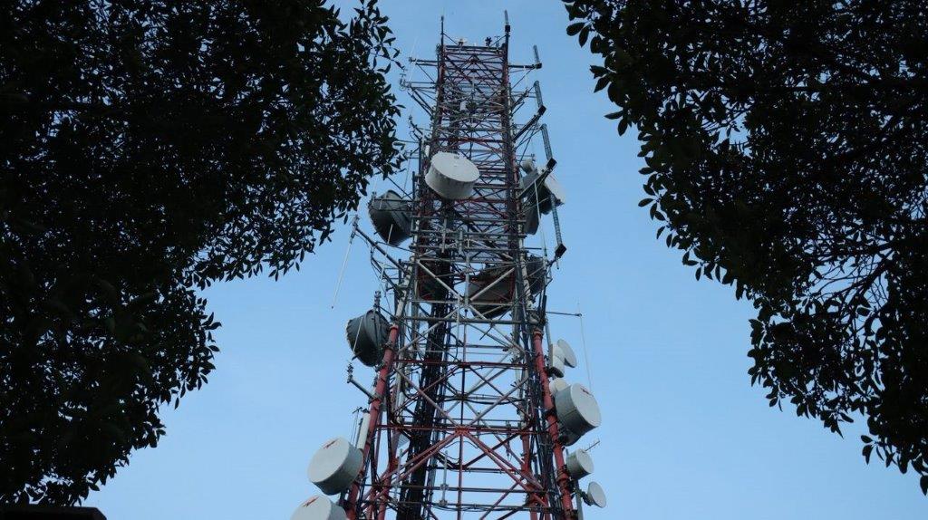 A tall metal tower with many satellite dishes

Description automatically generated