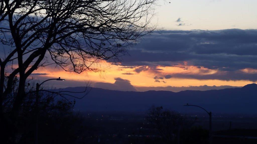 A sunset over a mountain range

Description automatically generated