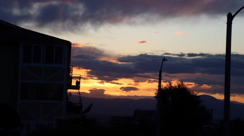 A sunset over a city

Description automatically generated