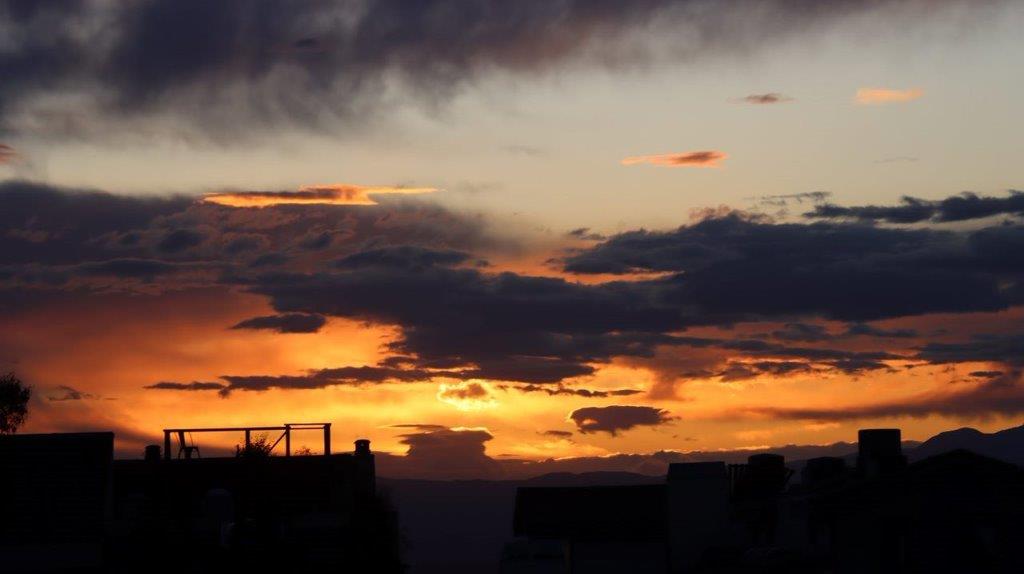 A sunset over a city

Description automatically generated