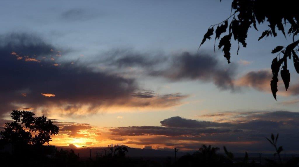 A sunset with clouds in the sky

Description automatically generated