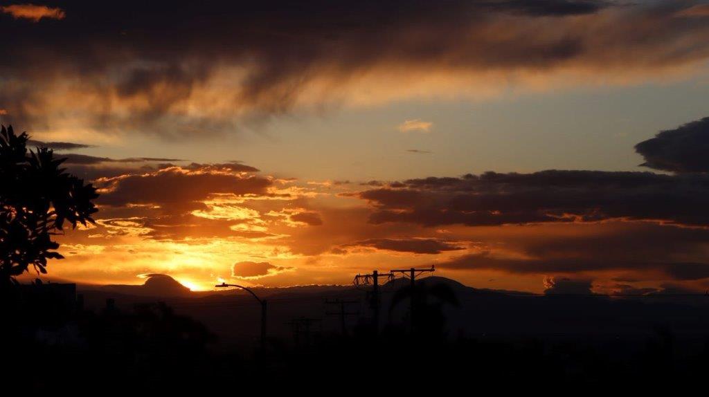 A sunset over a mountain

Description automatically generated