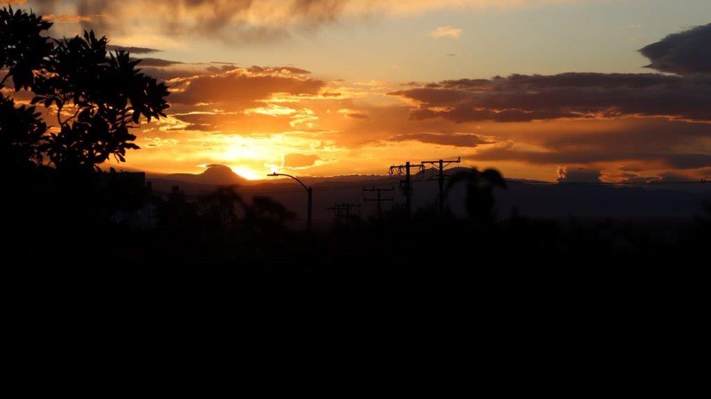 A sunset over a hill

Description automatically generated