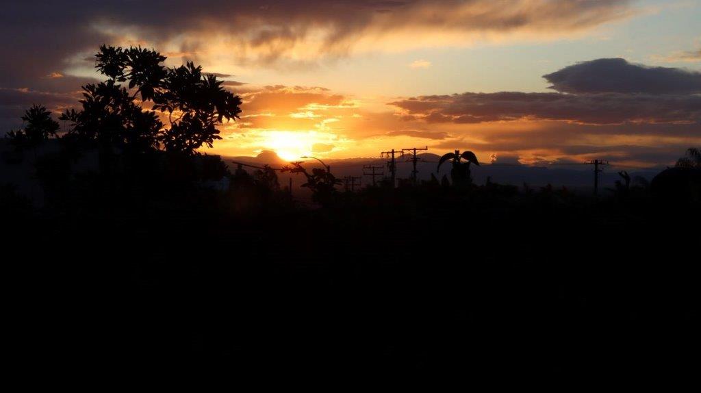 A sunset over a hill

Description automatically generated