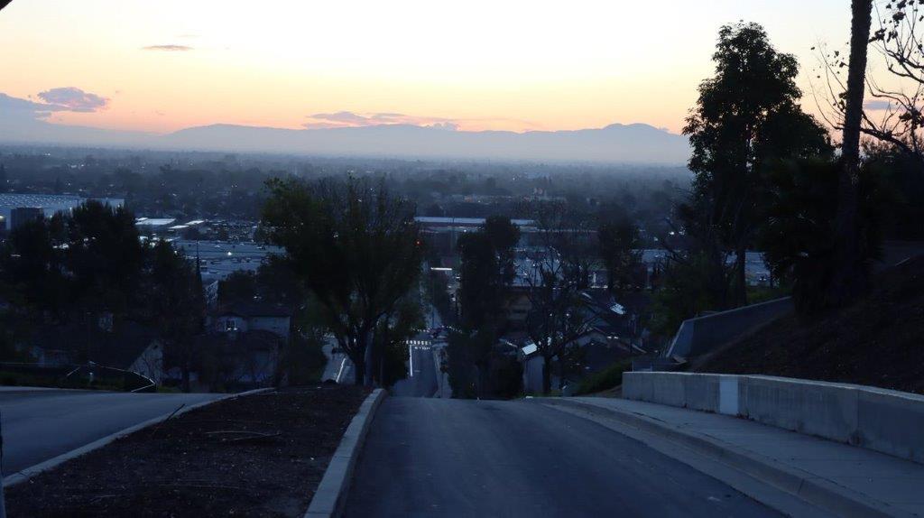 A road leading to a city

Description automatically generated