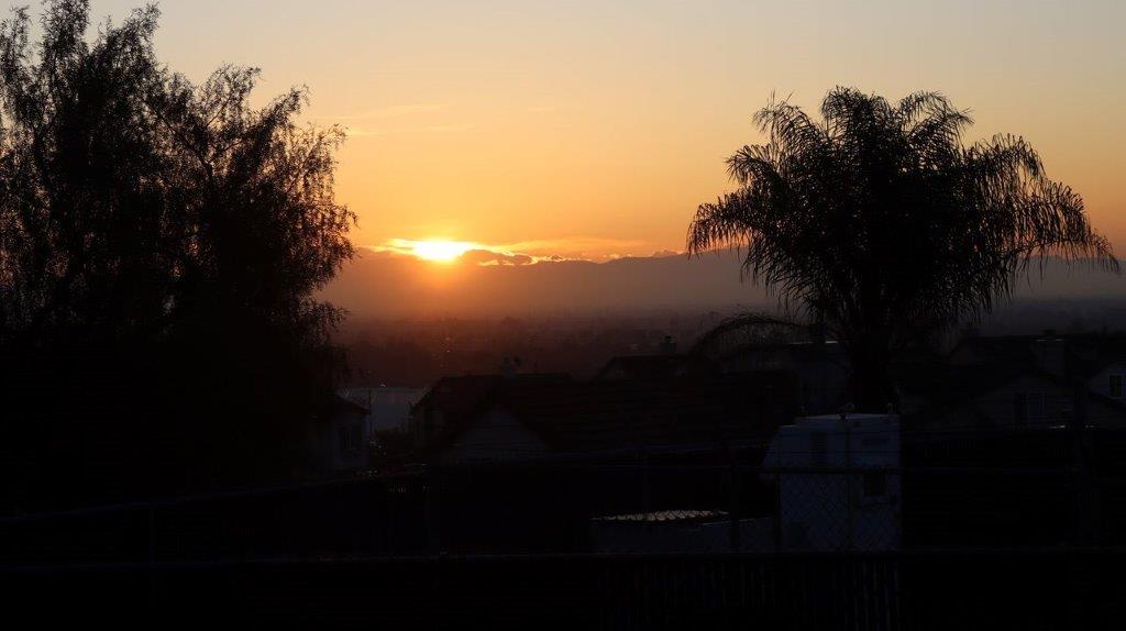 A sunset over a city

Description automatically generated