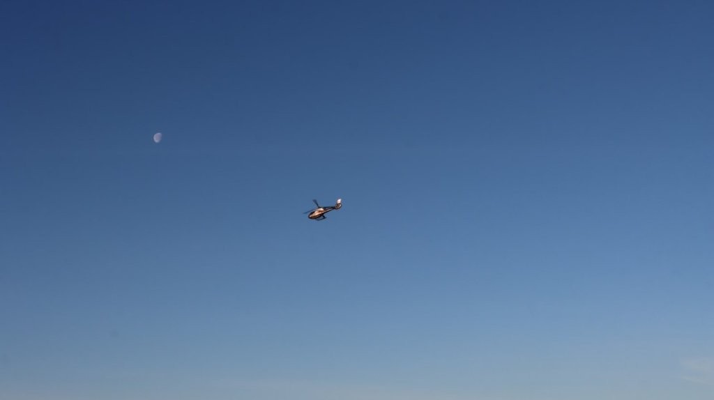 A helicopter flying in the sky

AI-generated content may be incorrect.