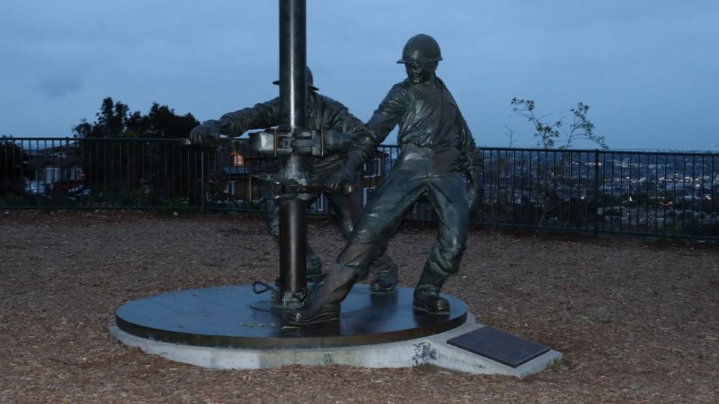 A statue of a person holding a person's leg

AI-generated content may be incorrect.