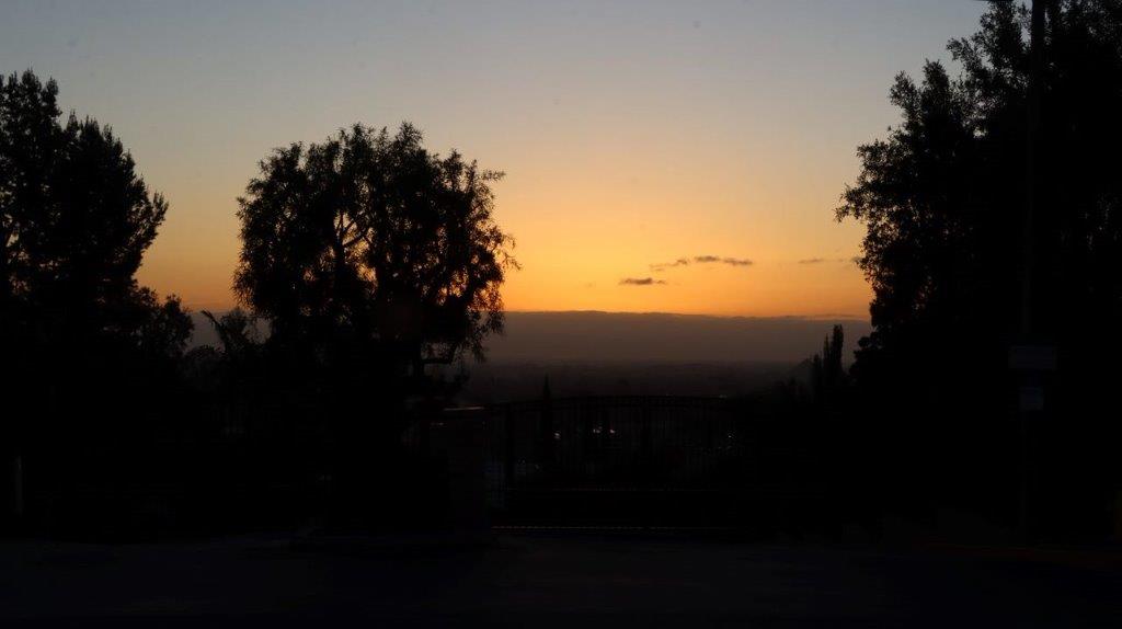 A silhouette of trees and a sunset

Description automatically generated