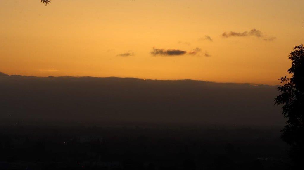 A sunset over a mountain range

Description automatically generated
