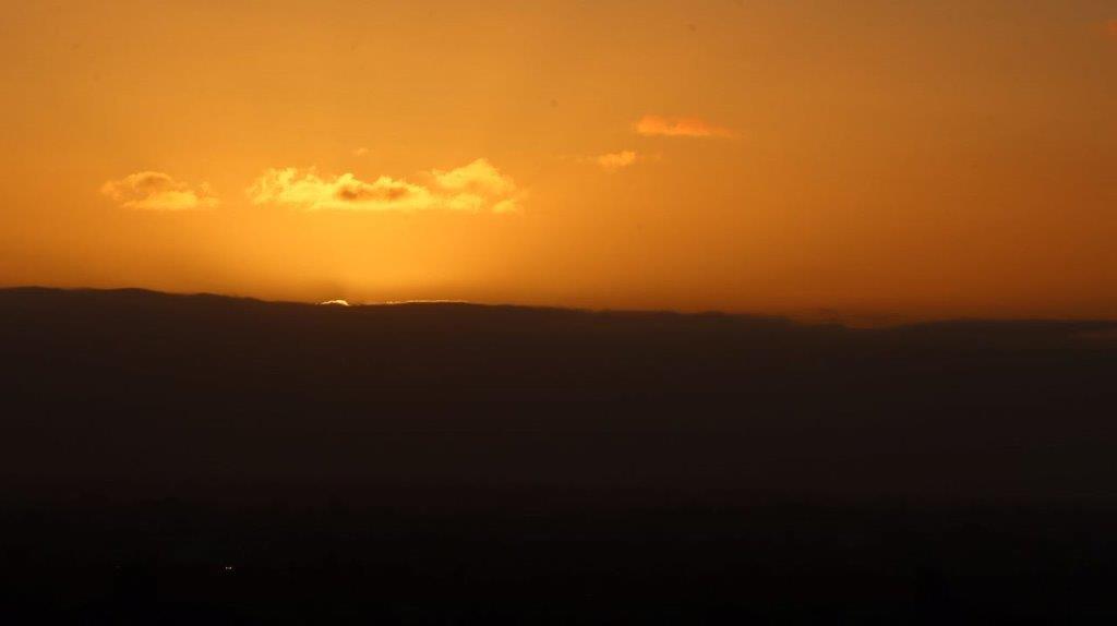 A sunset over a mountain

Description automatically generated