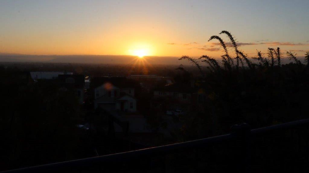 A sunset over a city

Description automatically generated