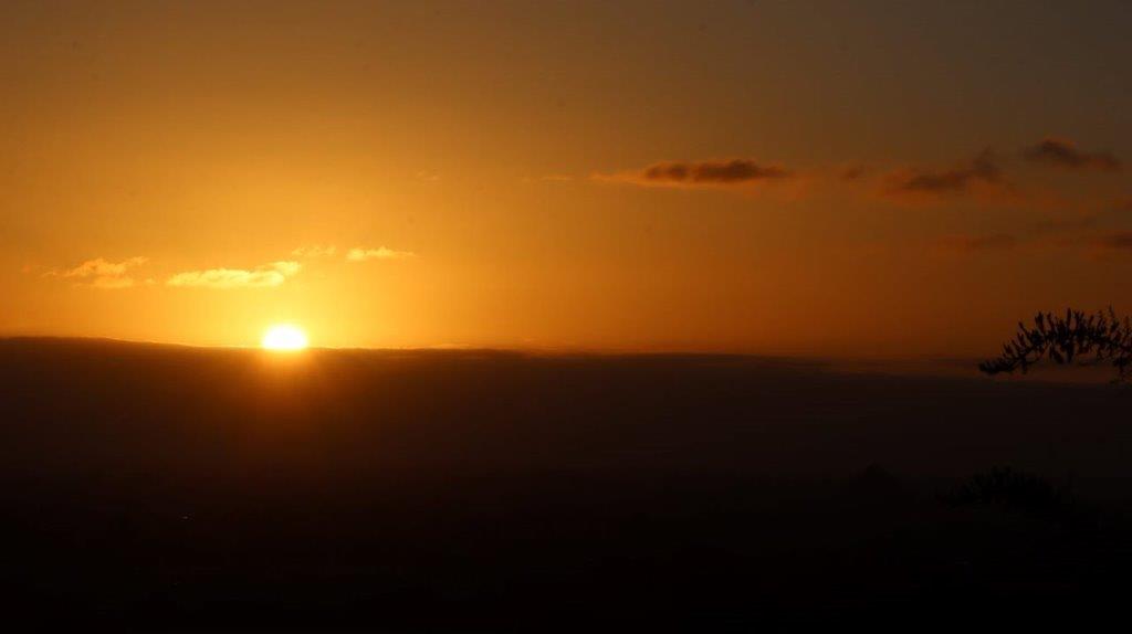 A sunset over a hill

Description automatically generated