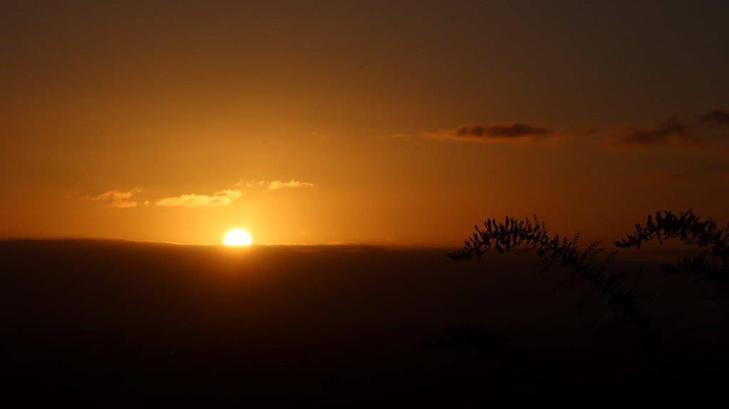 A sunset over a hill

Description automatically generated