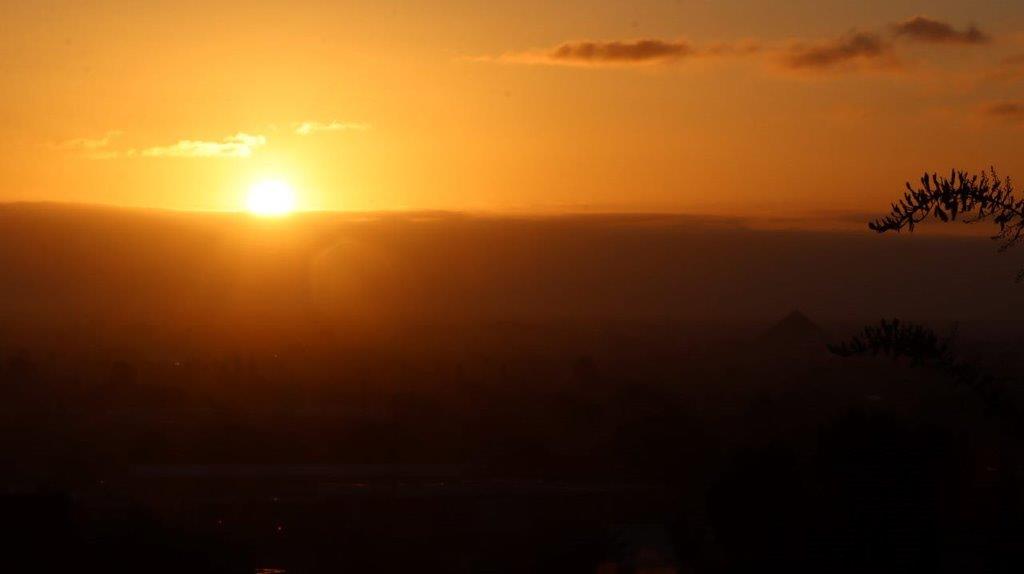 A sunset over a city

Description automatically generated