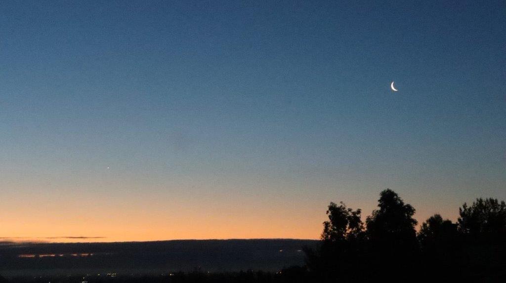 A moon in the sky

Description automatically generated