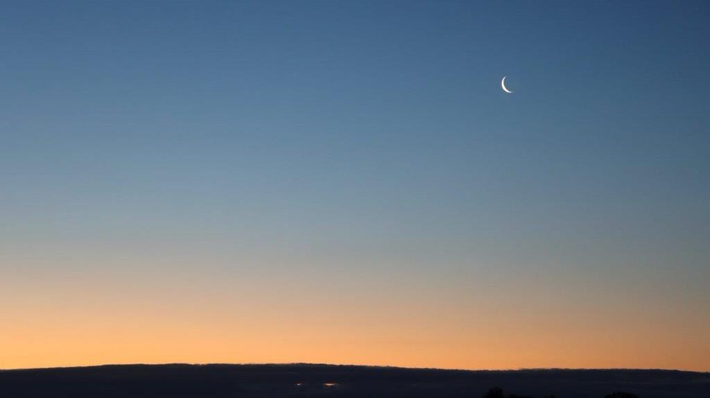 A crescent moon in the sky

Description automatically generated
