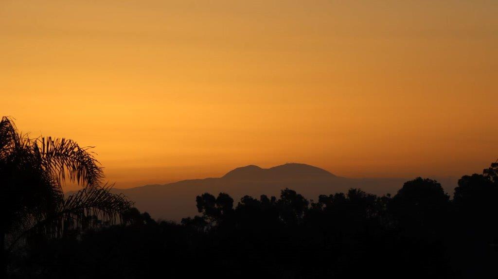 A sunset over a mountain range

Description automatically generated