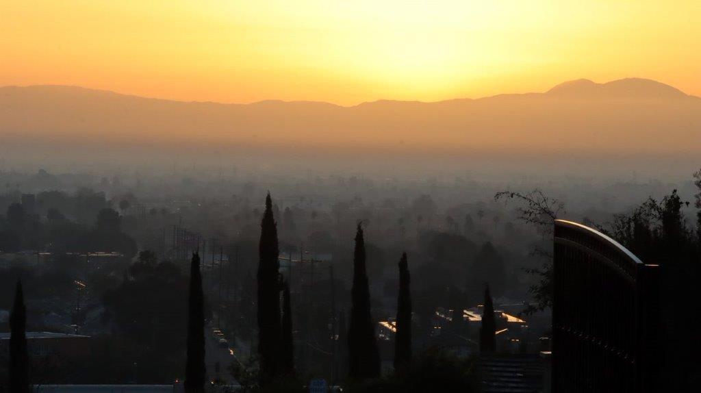 A sunset over a city

Description automatically generated