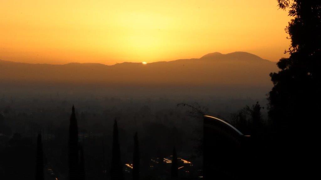 A sunset over a city

Description automatically generated