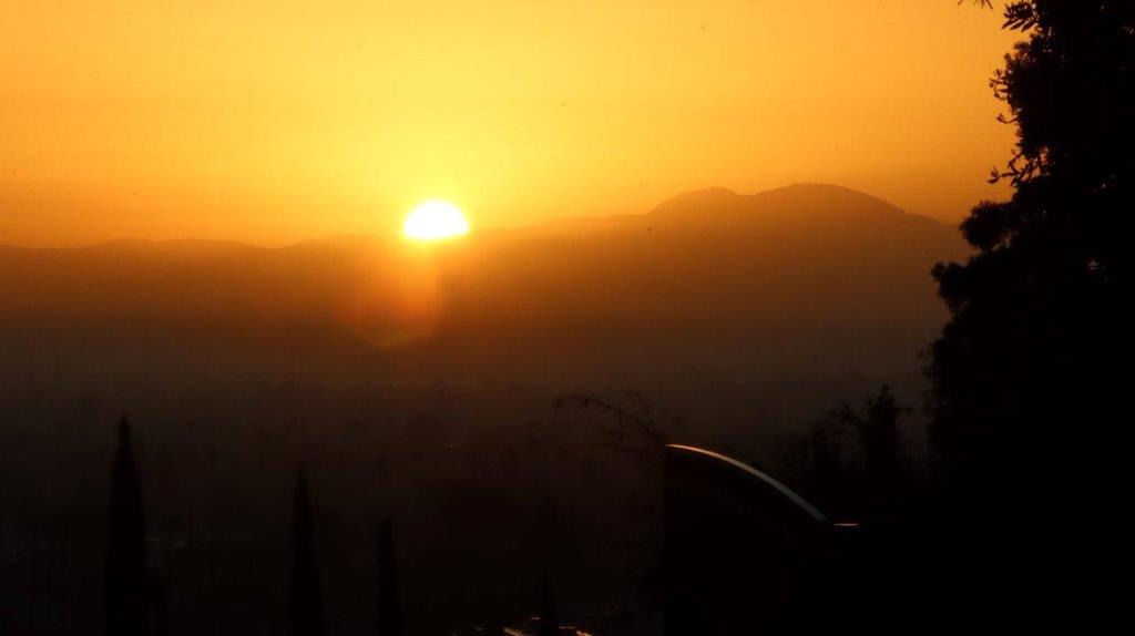 A sunset over a mountain range

Description automatically generated
