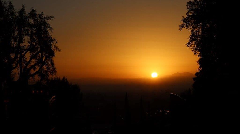 A sunset over a mountain

Description automatically generated