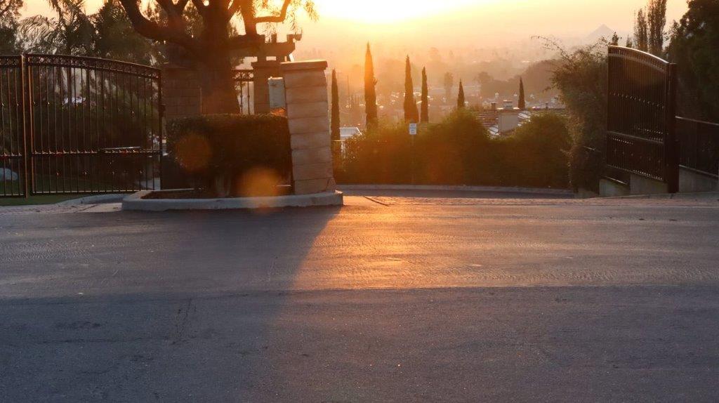 A sun setting over a road

Description automatically generated