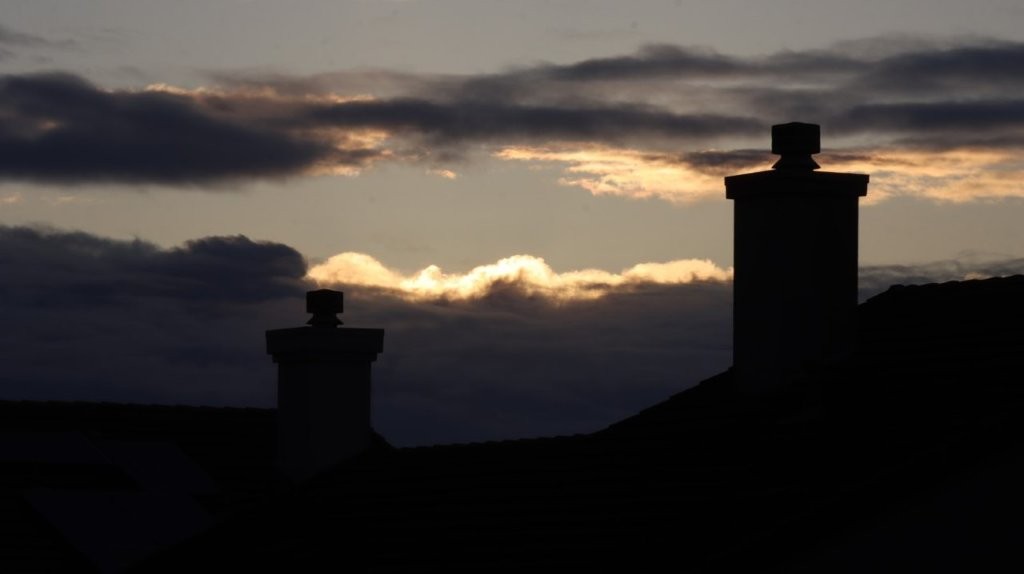 A silhouette of a building with a cloudy sky

AI-generated content may be incorrect.