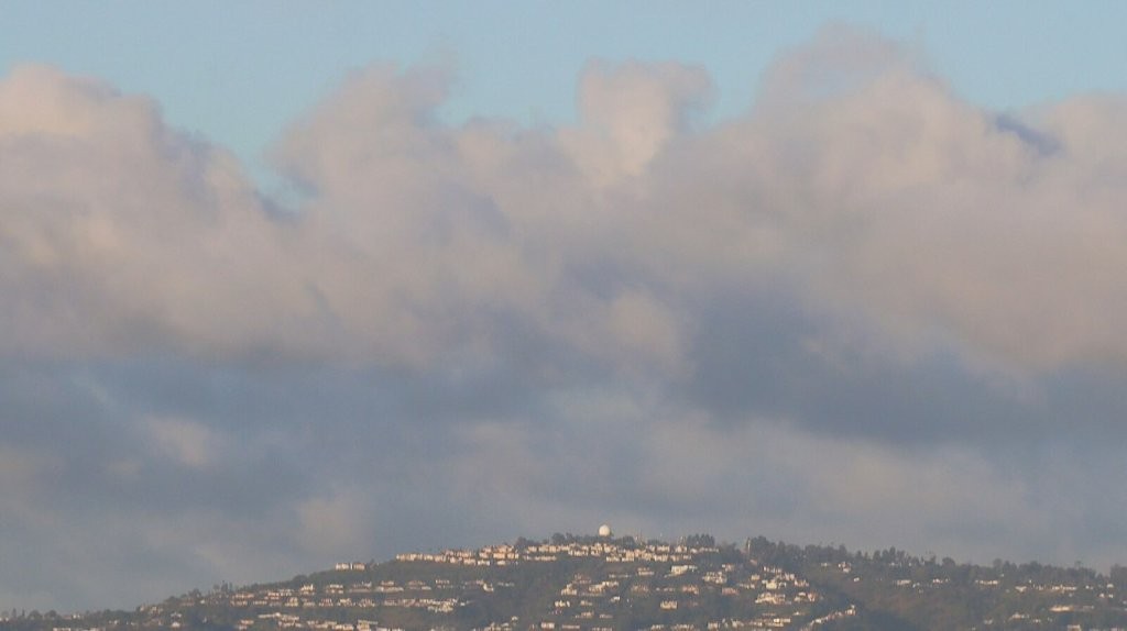 A cloudy sky over a hill

AI-generated content may be incorrect.